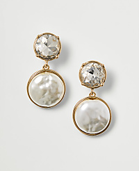 A pair of gold-toned drop earrings, each featuring a clear crystal stud above a lustrous pearl disc, are presented against a plain white background. carousel Product Image 1
