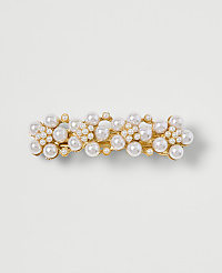 A gold barrette adorned with clusters of pearls sits on a plain, light-colored background. carousel Product Image 1