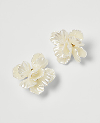 Two delicate, pearl-white floral earrings rest on a plain white background. carousel Product Image 1