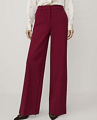 A person stands in front of a plain white background, wearing high-waisted, wide-leg burgundy pants and a patterned blouse. carousel Product Image 2