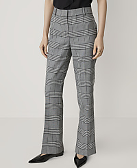 A person stands in front of a plain white background, wearing plaid flared trousers and black pointed-toe flats. carousel Product Image 2