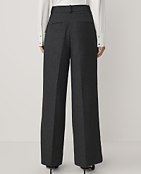 A person stands in dark grey wide-leg trousers and a white shirt against a plain white background. carousel Product Image 3