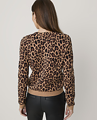 A woman in a leopard print sweater and black pants stands against a plain white background. carousel Product Image 2