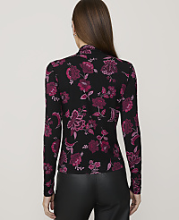A woman in a black floral top and leather pants stands against a plain gray background. carousel Product Image 2