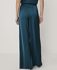 A person stands in teal satin wide-leg pants against a plain white background. carousel Product Image 3
