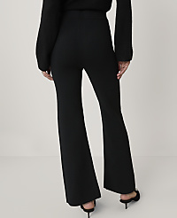 A person wearing black flared pants and a black sweater stands against a plain white background. carousel Product Image 3