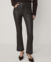 A person in dark brown, high-waisted, flared pants and brown mules stands against a plain, light brown background. carousel Product Image 2
