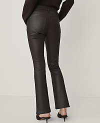 A person wearing dark brown, flared pants stands against a plain, light background. carousel Product Image 3