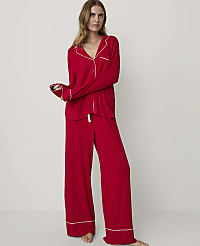 A woman in red pajamas stands against a plain white background. carousel Product Image 1