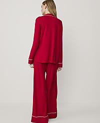 A woman in red pajamas stands against a plain white background. carousel Product Image 2