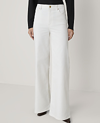 A person stands in white wide-leg jeans and a black top against a plain white background. carousel Product Image 2