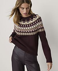 A woman in a burgundy sweater with a fair isle pattern stands against a plain white background. carousel Product Image 1
