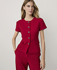 A woman in a red jacket and pants stands against a plain gray background. carousel Product Image 1