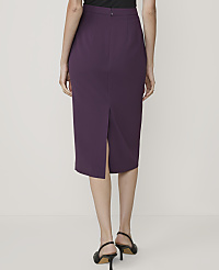 A woman in a purple pencil skirt and black heels stands against a plain white background. carousel Product Image 3