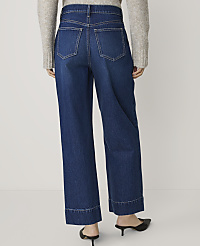 A person wearing wide-leg denim jeans and black heels stands against a plain white background. carousel Product Image 3