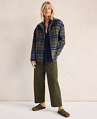 A woman in a plaid jacket and olive pants stands against a plain, textured background. carousel Product Image 6