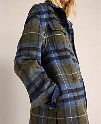A person in a blue and green plaid jacket stands against a plain, light-colored background. carousel Product Image 4