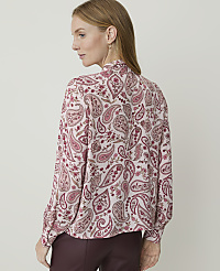 A woman in a pink paisley blouse and burgundy pants stands against a plain, light-colored background. carousel Product Image 2