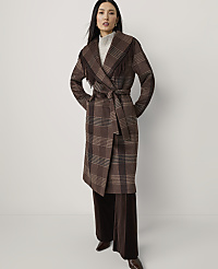 A woman in a brown plaid coat with fringe stands against a plain white background. carousel Product Image 1