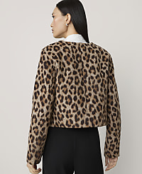 A woman in a leopard print jacket and black pants stands against a plain, light-colored background. carousel Product Image 2
