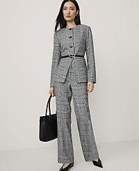 A woman in a grey plaid suit and black heels stands with a black tote bag against a plain white background. carousel Product Image 3