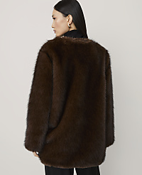 A woman in a brown faux fur coat stands against a plain white background. carousel Product Image 2