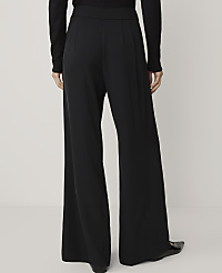 A person wearing black wide-leg pants stands against a plain white background. carousel Product Image 3