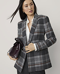 A woman in a gray plaid blazer and white blouse holds a burgundy handbag in front of a plain gray background. carousel Product Image 1