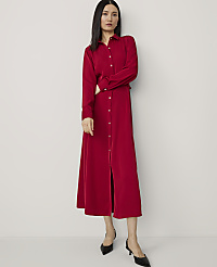 A woman in a red dress stands with her arms crossed against a plain white background. carousel Product Image 1