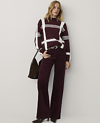A woman wearing a burgundy and white striped sweater and matching flared trousers stands against a plain white background. carousel Product Image 3