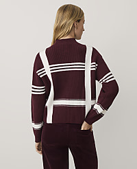 A woman wearing a burgundy and white plaid sweater and matching corduroy pants stands against a plain light gray background. carousel Product Image 2