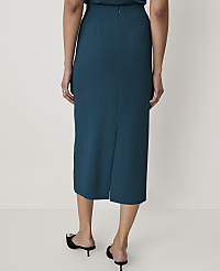 A person wearing a teal midi skirt and black pointed-toe mules stands against a plain white background. carousel Product Image 3