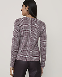A woman stands with her back to the camera wearing a maroon and white houndstooth blazer and dark trousers against a plain light grey background. carousel Product Image 2