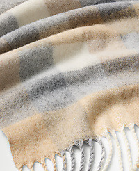 A soft, checkered wool scarf in beige, grey, and white tones is draped in the foreground over a plain white background. carousel Product Image 2