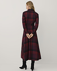 A woman wearing a red and black plaid dress and black boots stands with her back to the camera against a plain white background. carousel Product Image 2