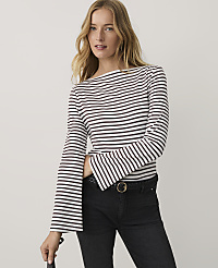 A woman wearing a striped long-sleeve top and black jeans stands against a plain white background. carousel Product Image 1