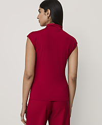 A woman wearing a red short-sleeved top and matching pants stands with her back to the camera against a plain light gray background. carousel Product Image 2