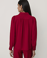 A woman wearing a red long-sleeved blouse and matching trousers stands with her back to the camera against a plain light gray background. carousel Product Image 2