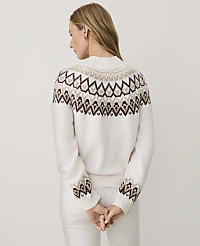 A woman wearing a white patterned sweater and white pants stands with her back to the camera against a plain light gray background. carousel Product Image 2