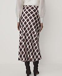 A person wearing a white blouse, a plaid midi skirt, and dark boots stands against a plain white background. carousel Product Image 3