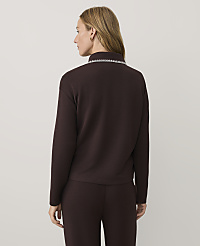 A woman wearing a dark burgundy long-sleeved top and matching pants stands with her back to the camera against a plain light gray background. carousel Product Image 2