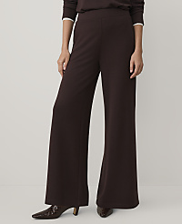 A person wears dark brown wide-leg trousers and matching shoes against a plain white background. carousel Product Image 2
