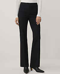 A person wearing a white long-sleeved top and black wide-leg trousers stands against a plain white background. carousel Product Image 3