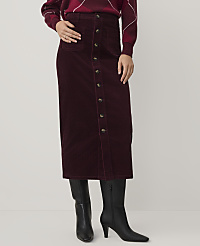 A person wears a burgundy corduroy button-down skirt and black boots against a plain white background. carousel Product Image 2