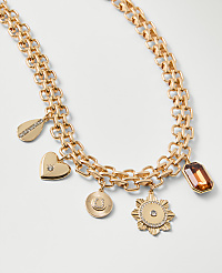 A gold chain necklace with various charms and a gemstone sits against a plain white background. carousel Product Image 2