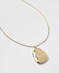 A gold chain necklace with a polished, organic-shaped pendant rests on a plain light gray background. carousel Product Image 2