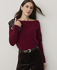 A woman wearing a burgundy sweater and brown velvet trousers stands against a plain white background. carousel Product Image 1