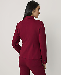 A woman wearing a red blazer and matching trousers stands with her back to the camera against a plain light grey background. carousel Product Image 2