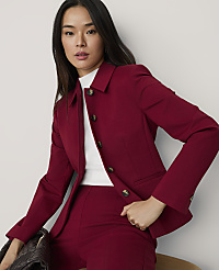 A woman wearing a red blazer and matching trousers over a white top poses against a plain white background. carousel Product Image 3