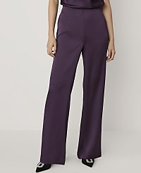 A person wearing purple wide-leg trousers and black pointed heels stands against a plain white background. carousel Product Image 2